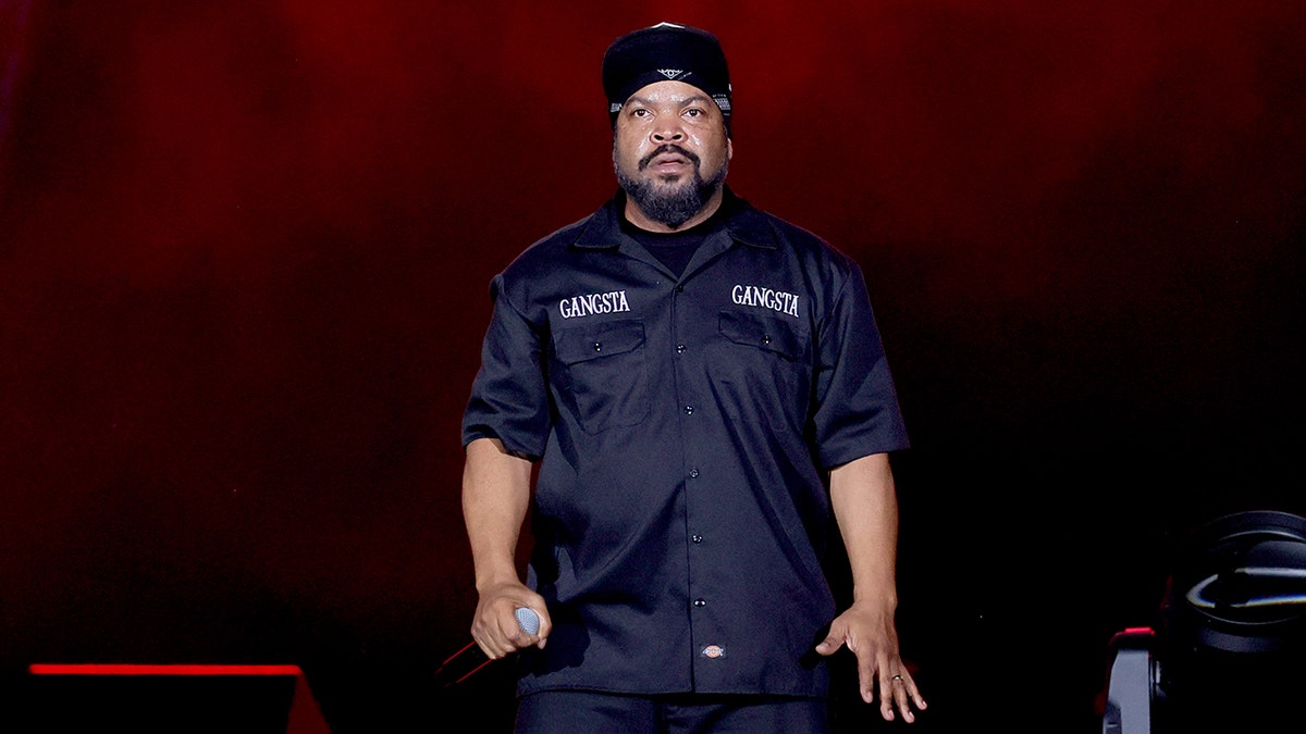 Ice Cube standing on stage with a microphone