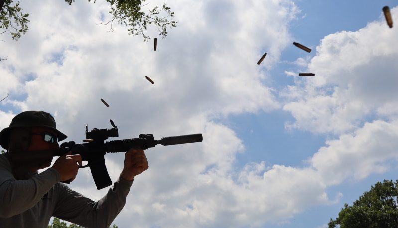 Casings ejecting from automatic rifle