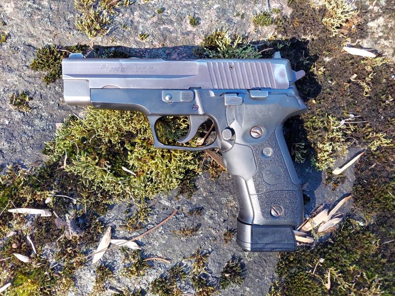 Sig P226 with extended magazine and Crimson Trace laser grip