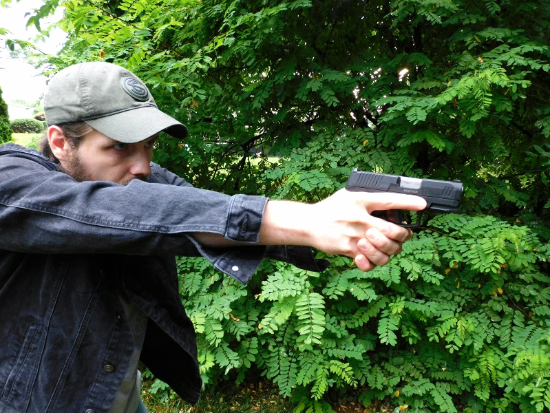 Man firing a concealed carry pistol