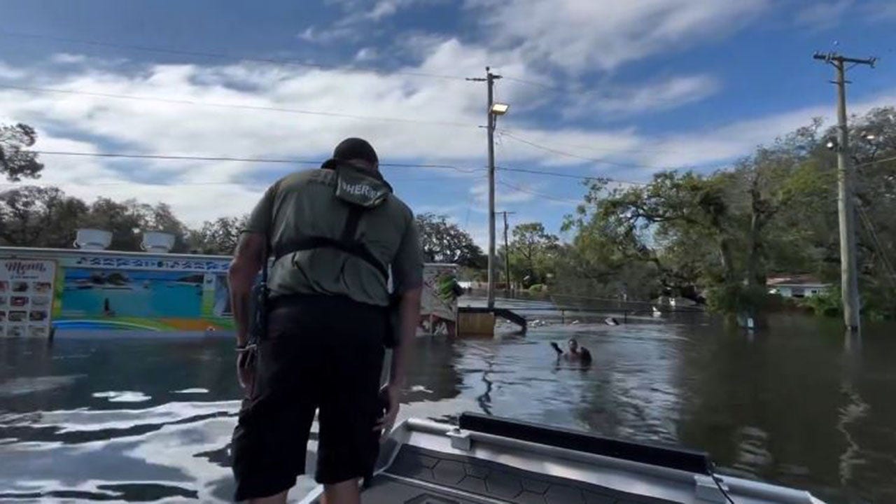 Florida deputies rescue boy floating on piece of fence in floodwaters