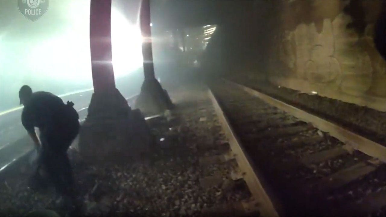 Heart-stopping video shows Seattle police rescue man from tracks moments before train roars past