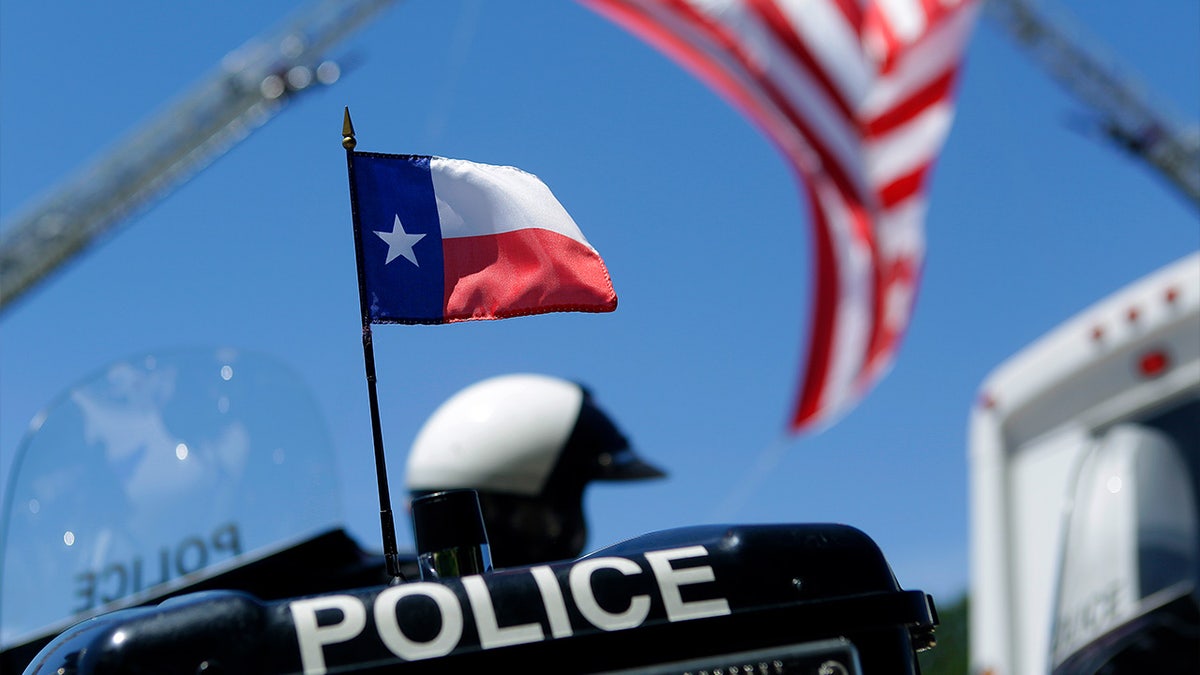 A Texas flag is on the back of a police motorcycle