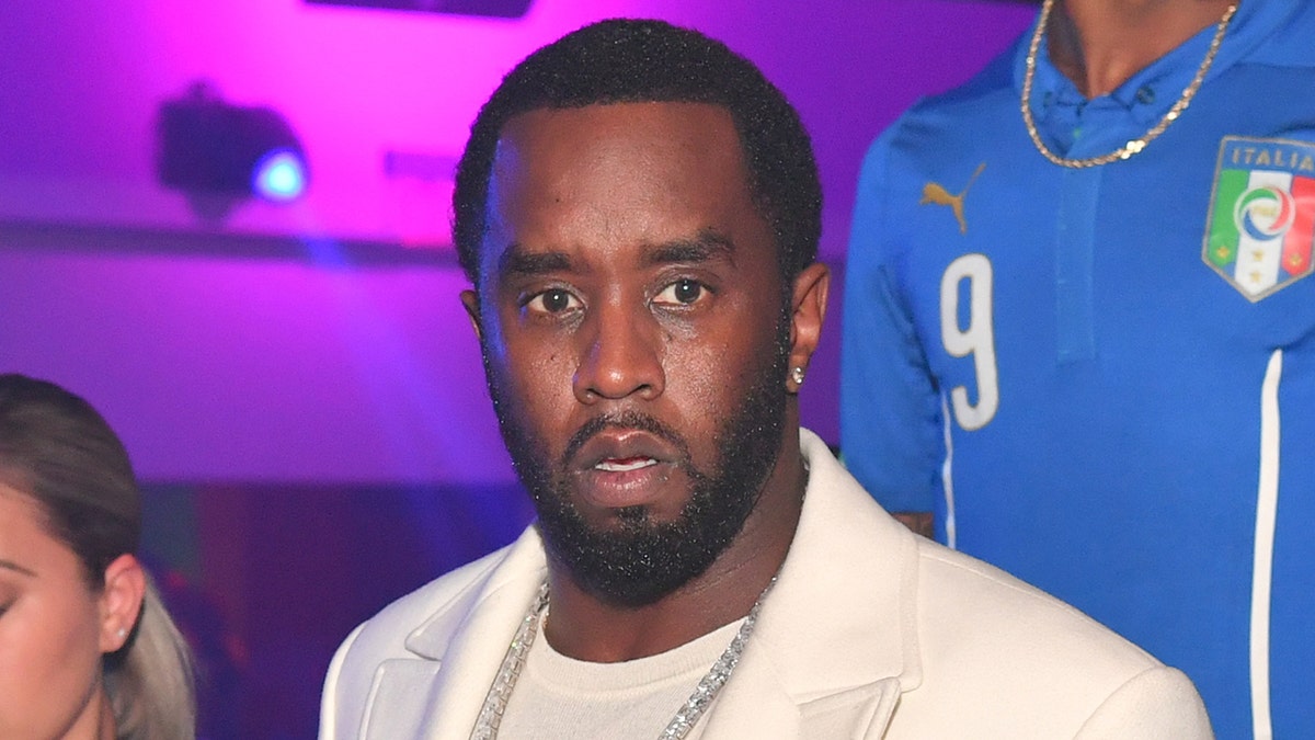 Sean Diddy Combs steps out wearing a white blazer with matching shirt.