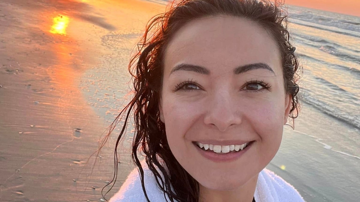 Mica Miller on a beach at sunset