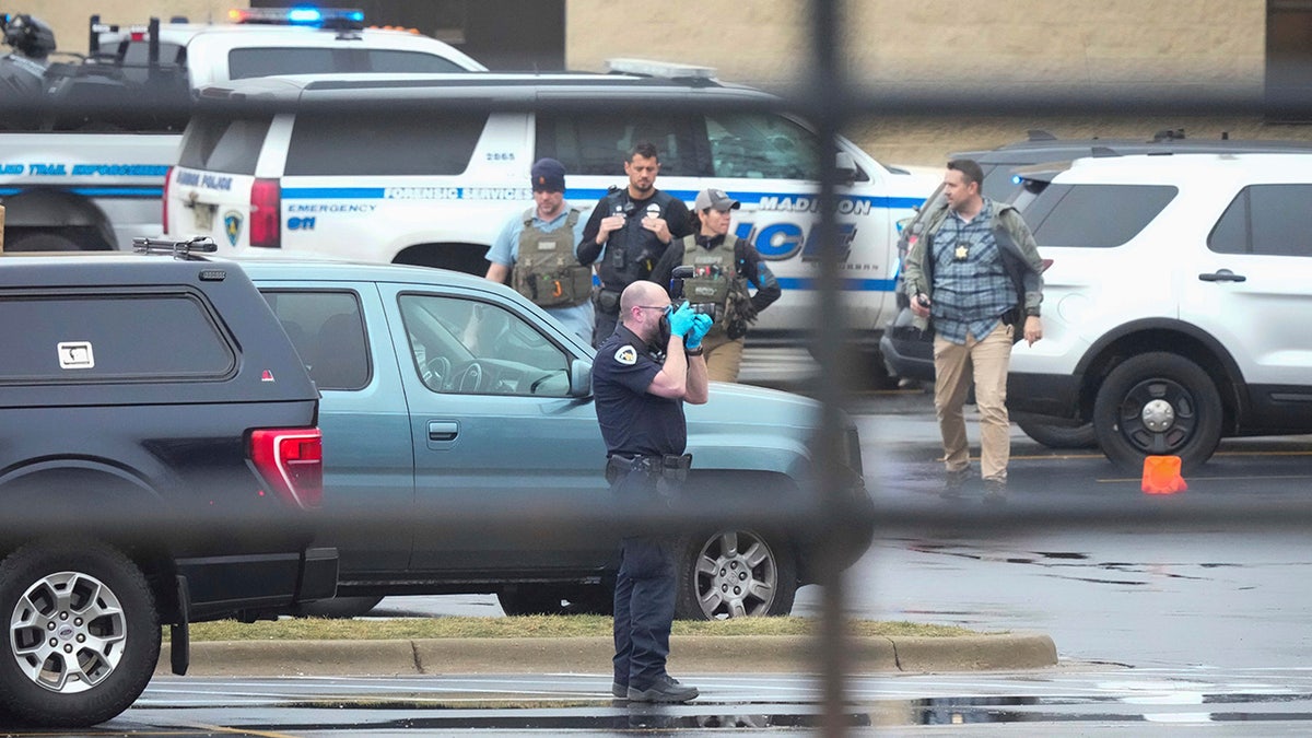 Police guard as emergency vehicles are parked outside the Abundant Life Christian School