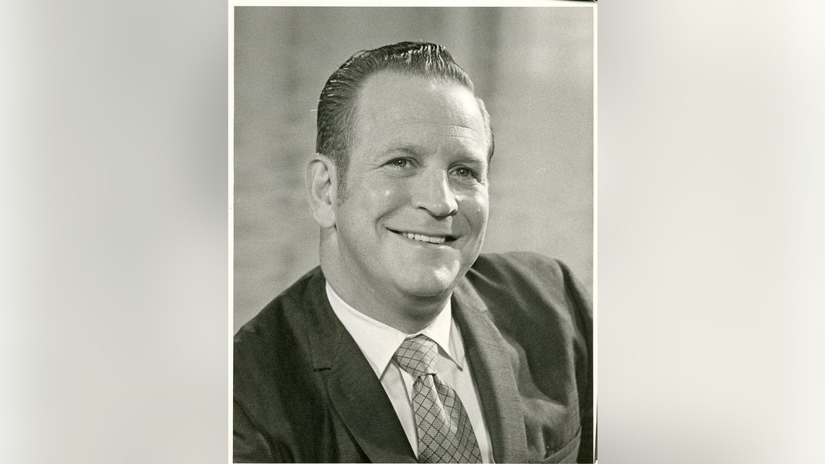 Edward Wayne Edwards in a suit smiling