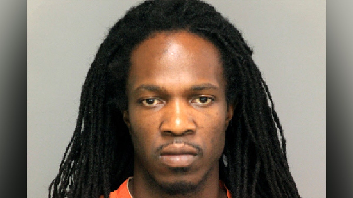 Brandon Council with long braided hair in mugshot