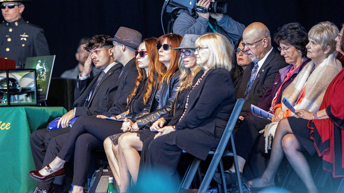 Family members of three fallen Palm Beach County Sheriff's Deputies attend a memorial service for their love ones