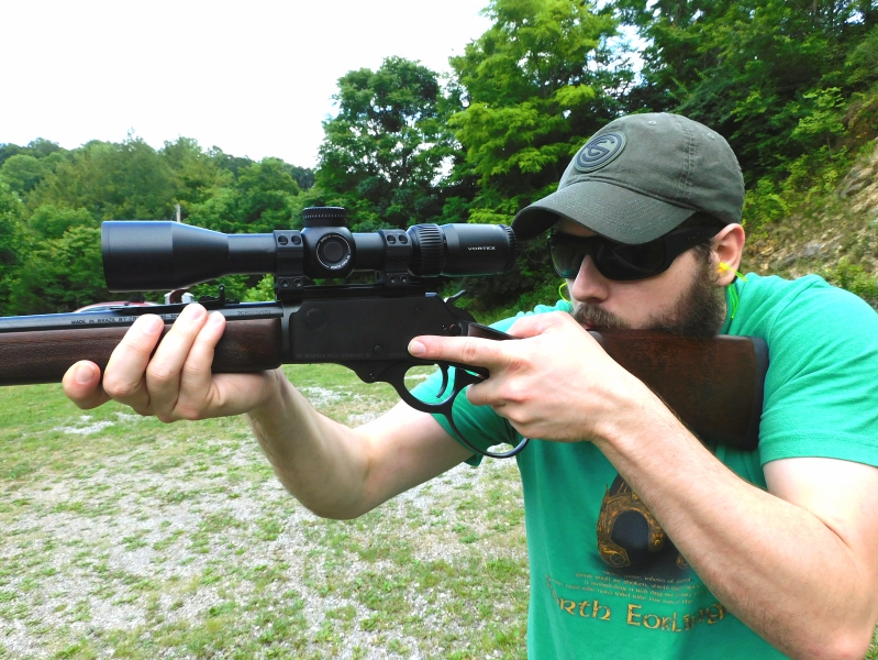 Man firing a Rossi R95 .30-30 rifle