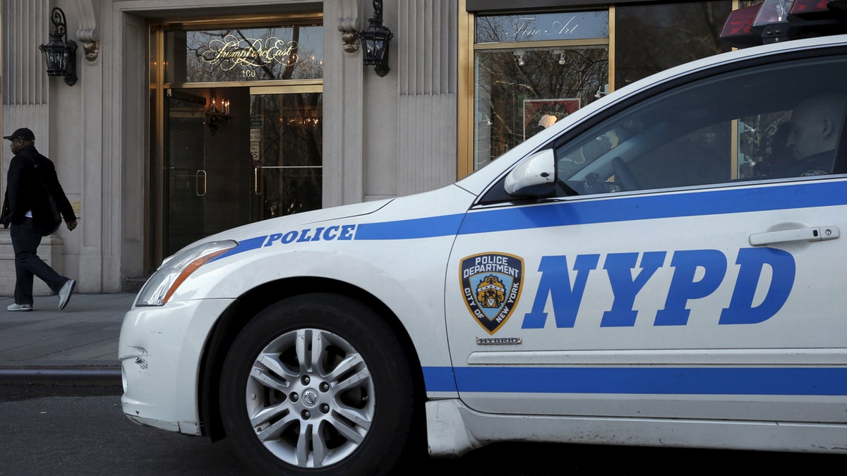 A New York City Police (NYPD) car is parked outside the entrance to Trump Parc East, a luxury apartment building in mid-Manhattan, which is home to Eric Trump, the son of presidential candidate Donald Trump, in New York March 18, 2016. REUTERS/Brendan McDermid - RTSB3TU