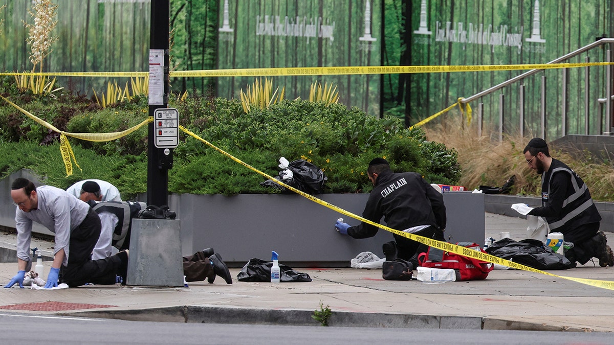 Members of the group Misaskim clean blood off the ground