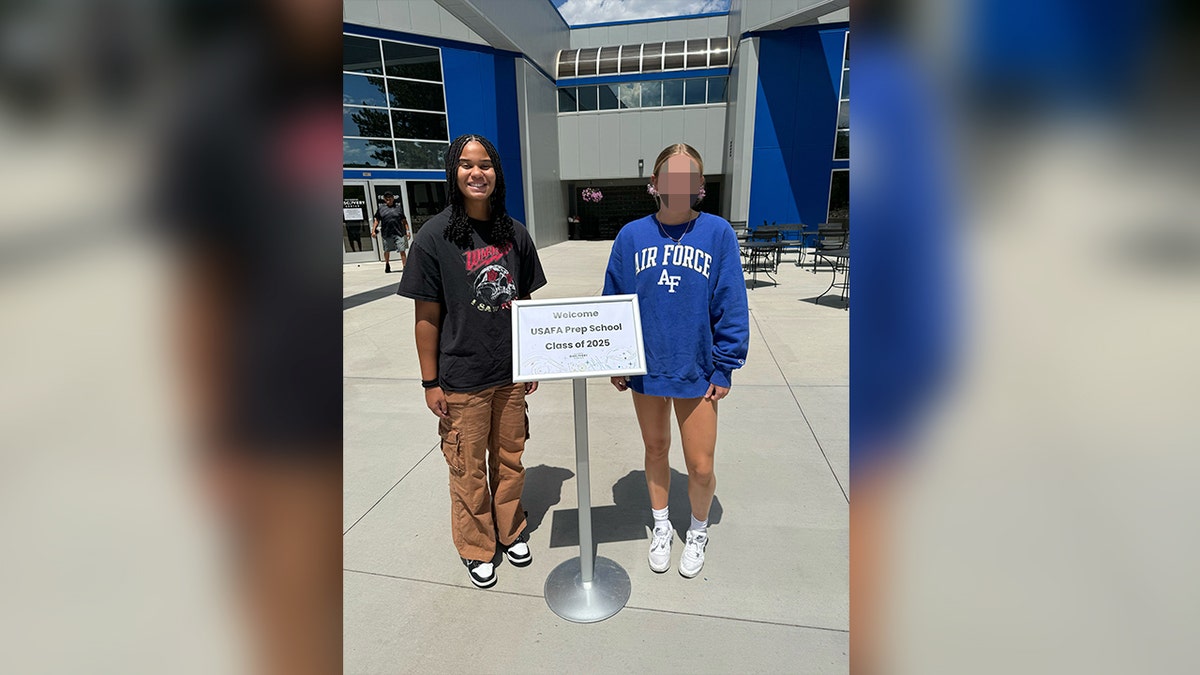 Ava Moore stands in front of an Air Force Prep clas of 2025 sign