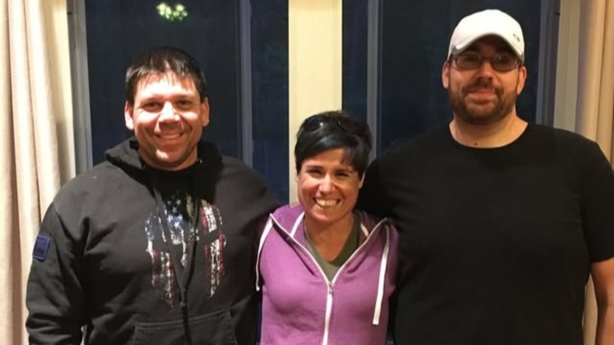 Jeff Guida (right) poses with his family members