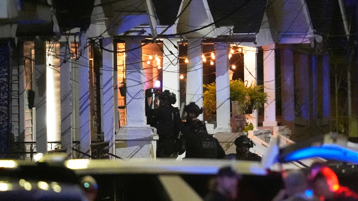 Louisiana state police enter a house on North Galvez street as they pursue a fugitive that escaped from a New Orleans jail, Tuesday, May 20, 2025, in New Orleans.