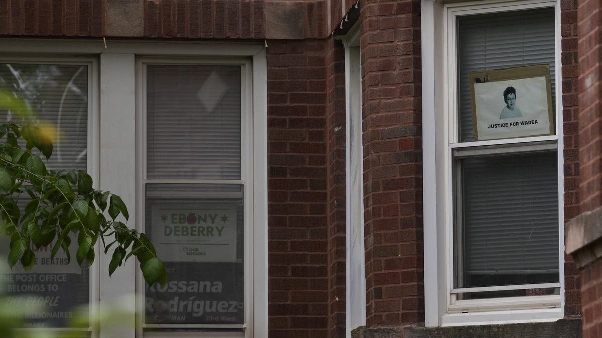 Signs are seen in the window of a building