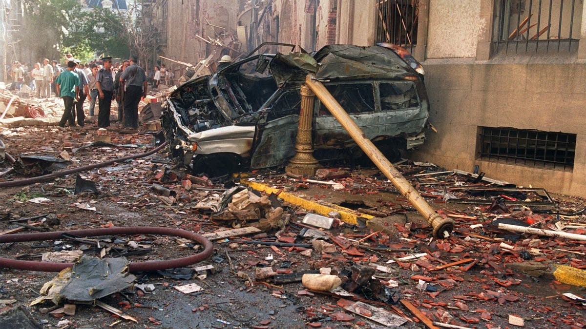  Police and rescue workers stand near destroyed cars and debris on March 17, 1992, in Buenos Aires shortly after a powerful bomb ripped through the Israeli Embassy, virtually destroying the five-story building and killing 29 people. 