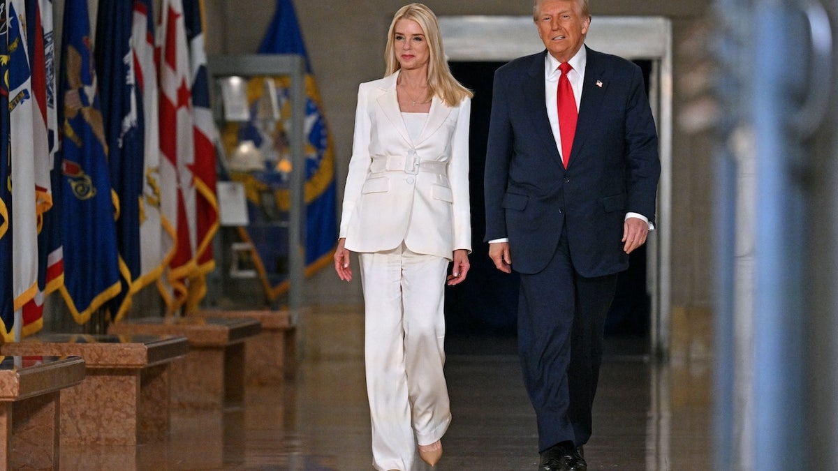US President Donald Trump and US Attorney General Pam Bondi (L) arrive to speak at the Department of Justice in Washington, D.C. (Roberto Schmidt/AFP via Getty)