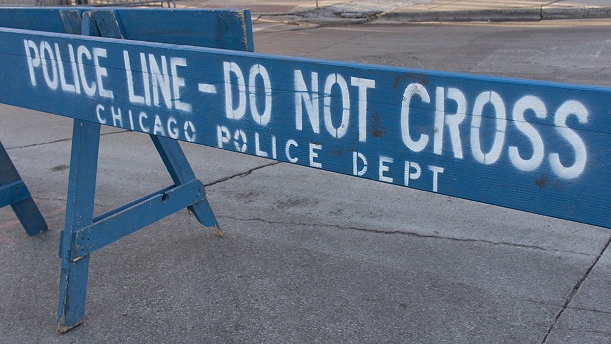Blue wooden police barricade on city street.