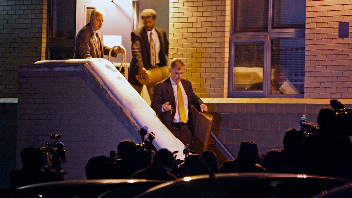 FBI agents stepping outside a building.