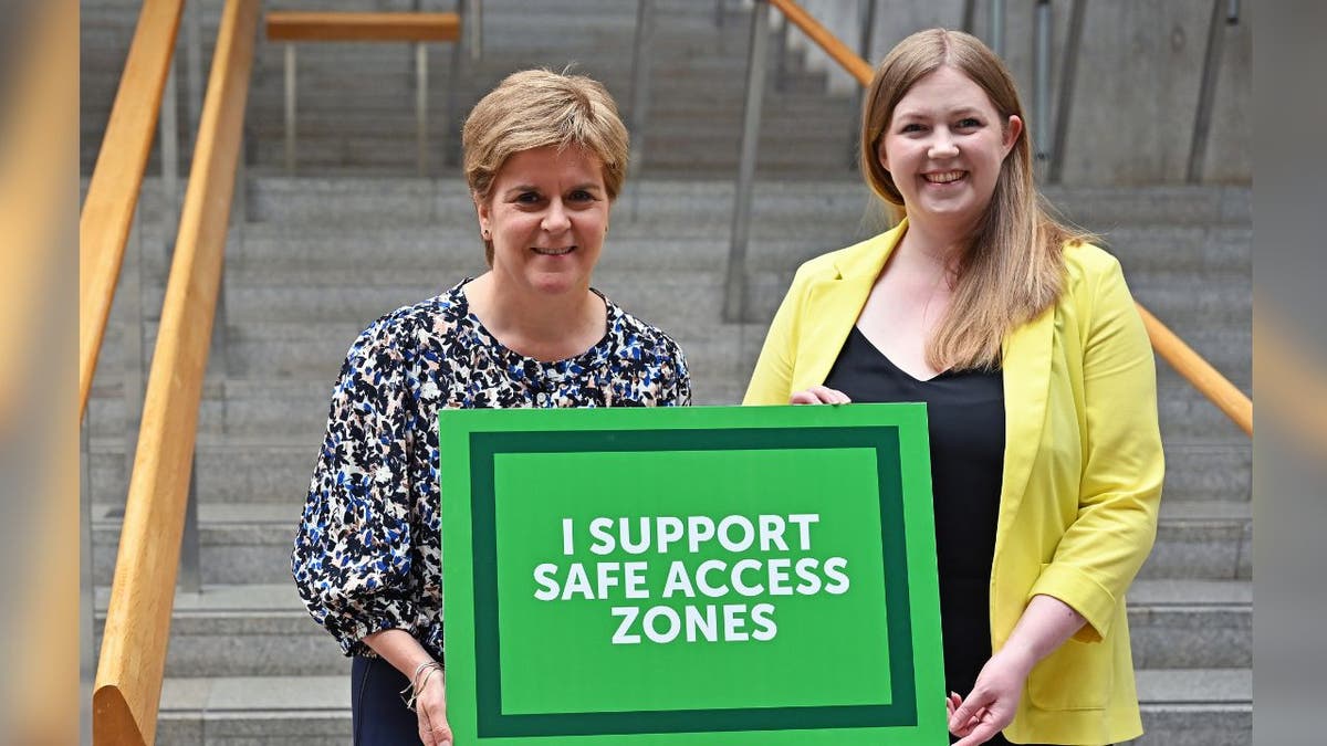 Nicola Sturgeon (L) poses for a photograph with Scottish Green 