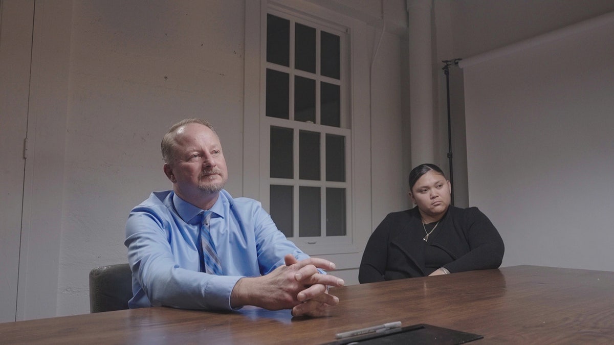 Brett Bartlett sitting with his assistant