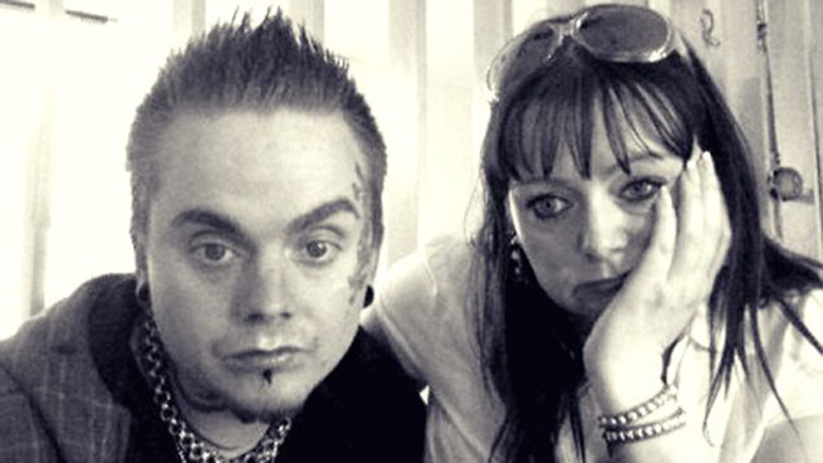 Isakin Jonsson posing for a photo while Helle Christensen looks on.