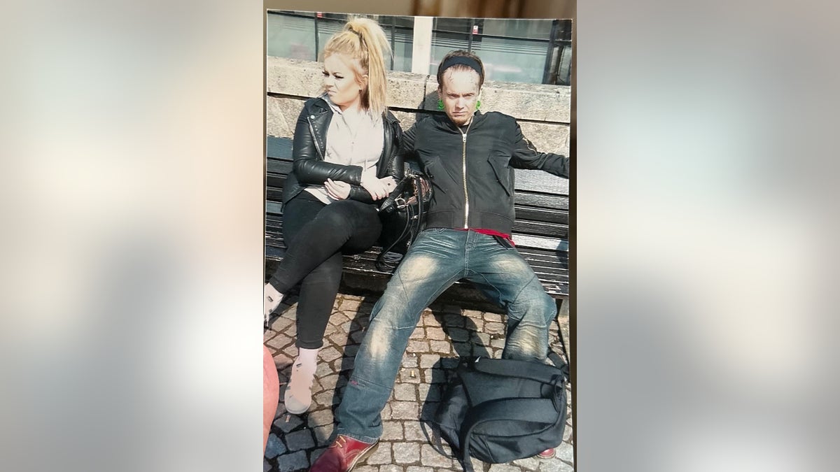 A young Jamie-Lee Arrow sitting next to her father Isakin on a bench.