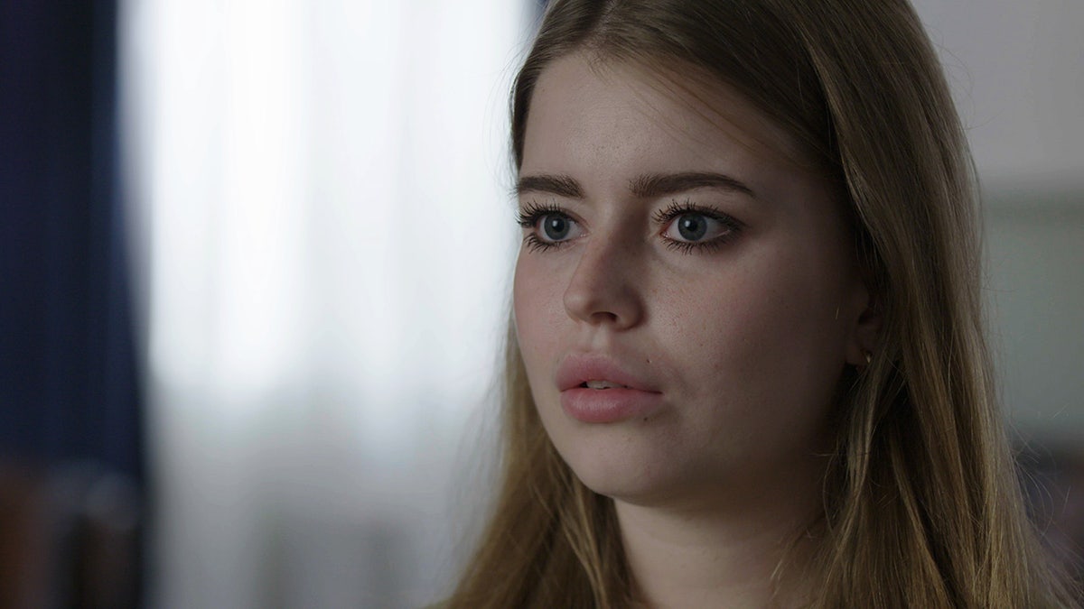 A close-up of Jamie-Lee Arrow looking to the side.