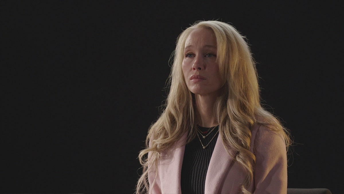 Sherri Papini wearing a beige sweater and a black shirt looking away from the camera.