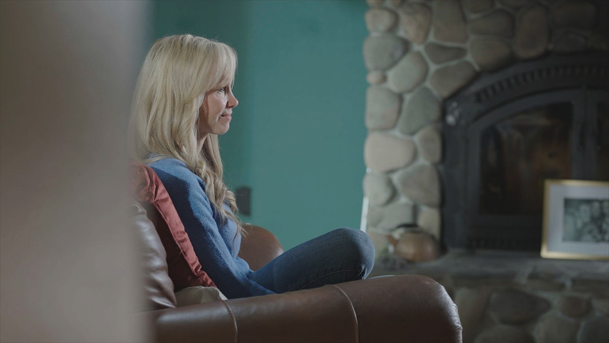 Sherri Papini looking away sitting on a couch..