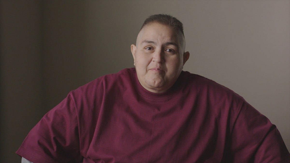 Monica De La Mora wearing a burgundy sweater