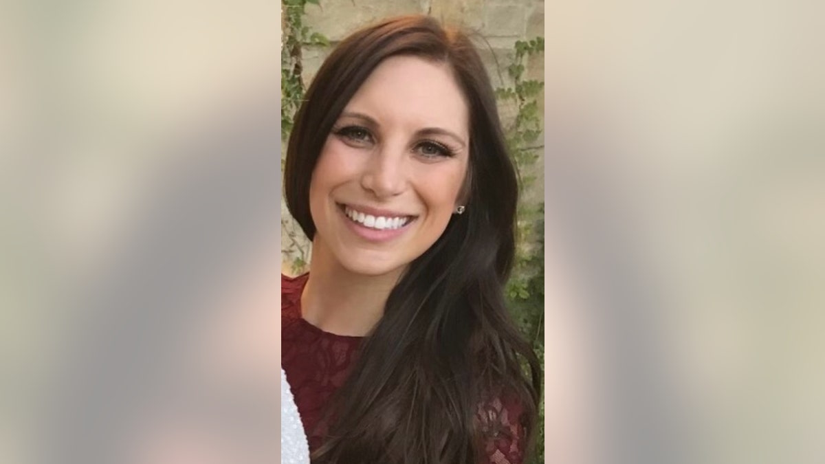 Caitlin Tracey wearing a red lace top