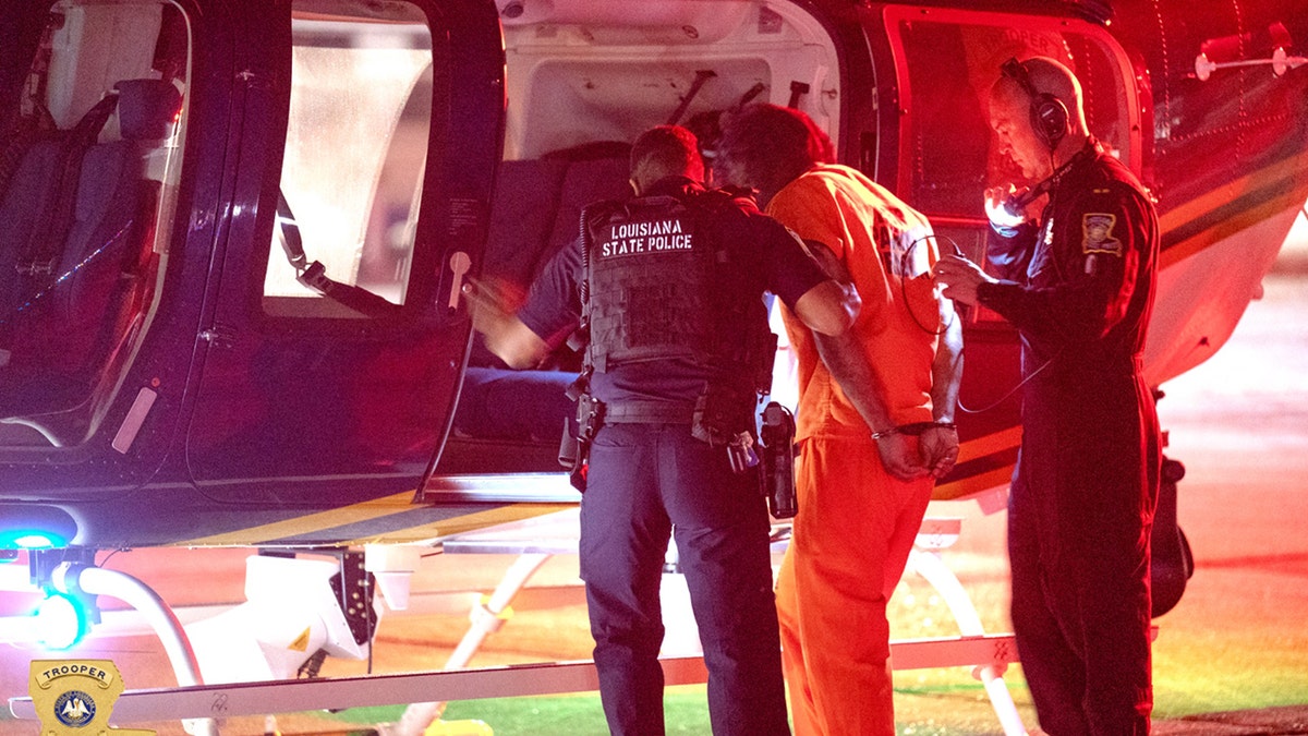 lenton vanburen in police custody being brought to helicopter