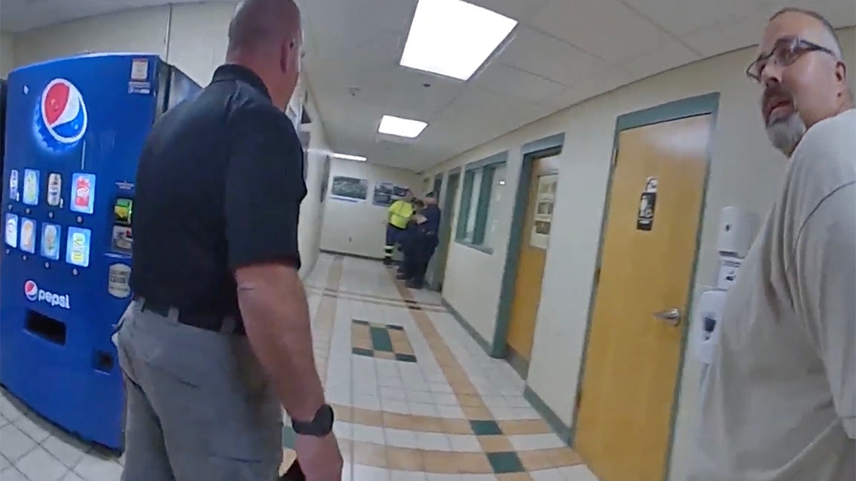 Mickey Stines and Kentucky State Police Investigator Clayton Stamford walk through the Letcher County Courthouse.