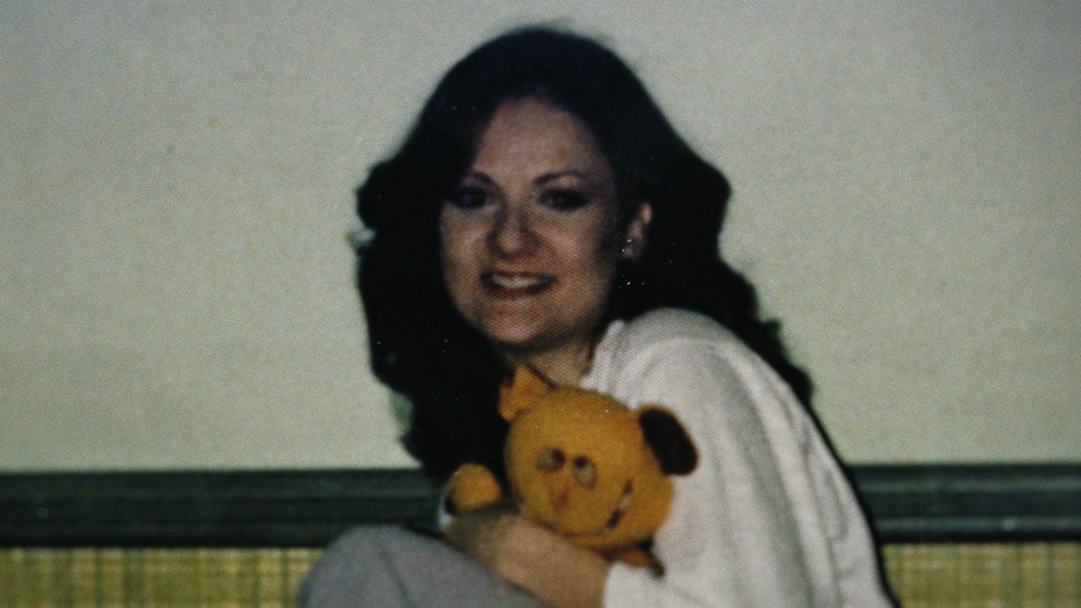 Diane Lee Roth holding a teddy bear.