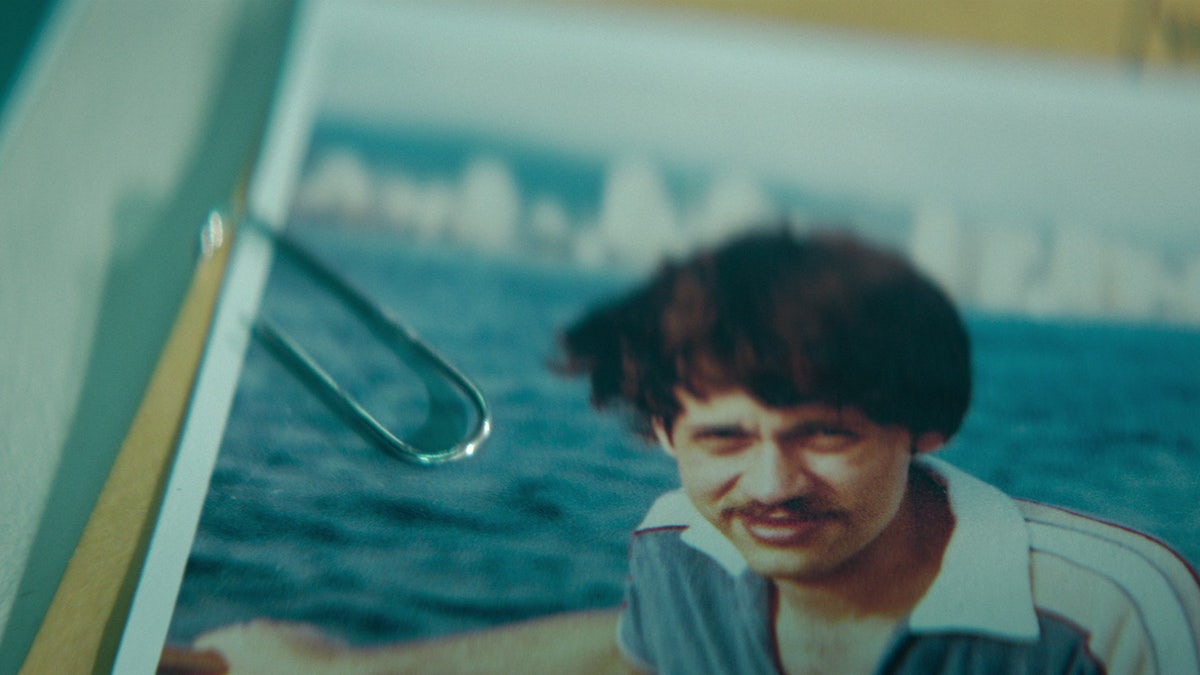 Photo of a man being held by a paper clip.