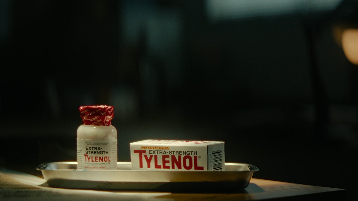 A bottle of Extra-Strength Tylenol next to its bottle.