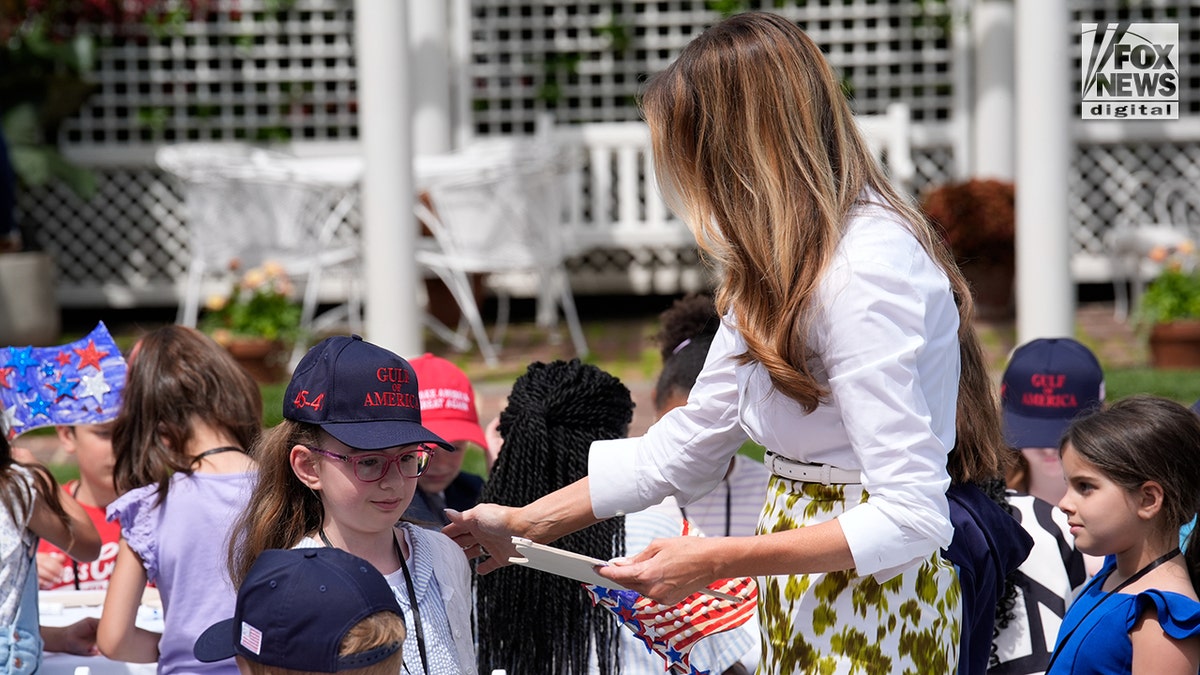 FLOTUS with children in the White House garden.