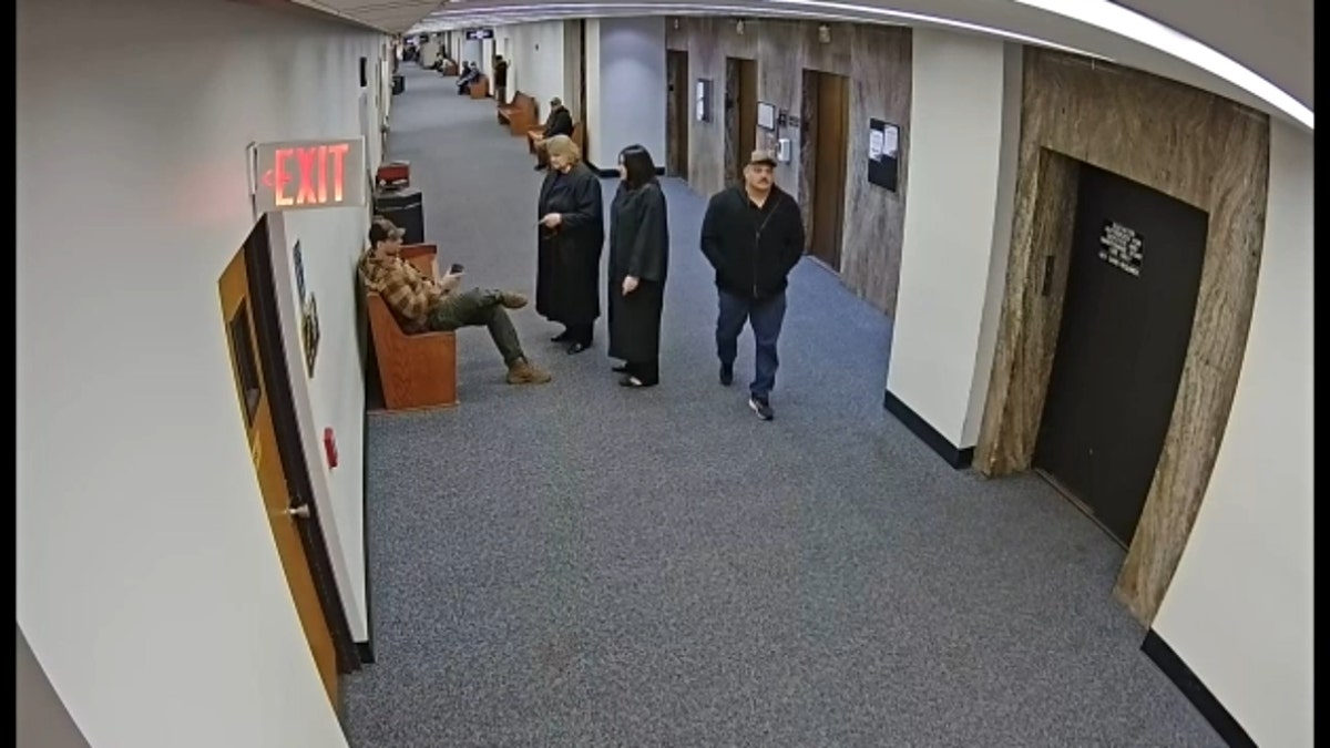 Judge Hannah Dugan appears to speak with ICE agents in the Milwaukee County Courthouse