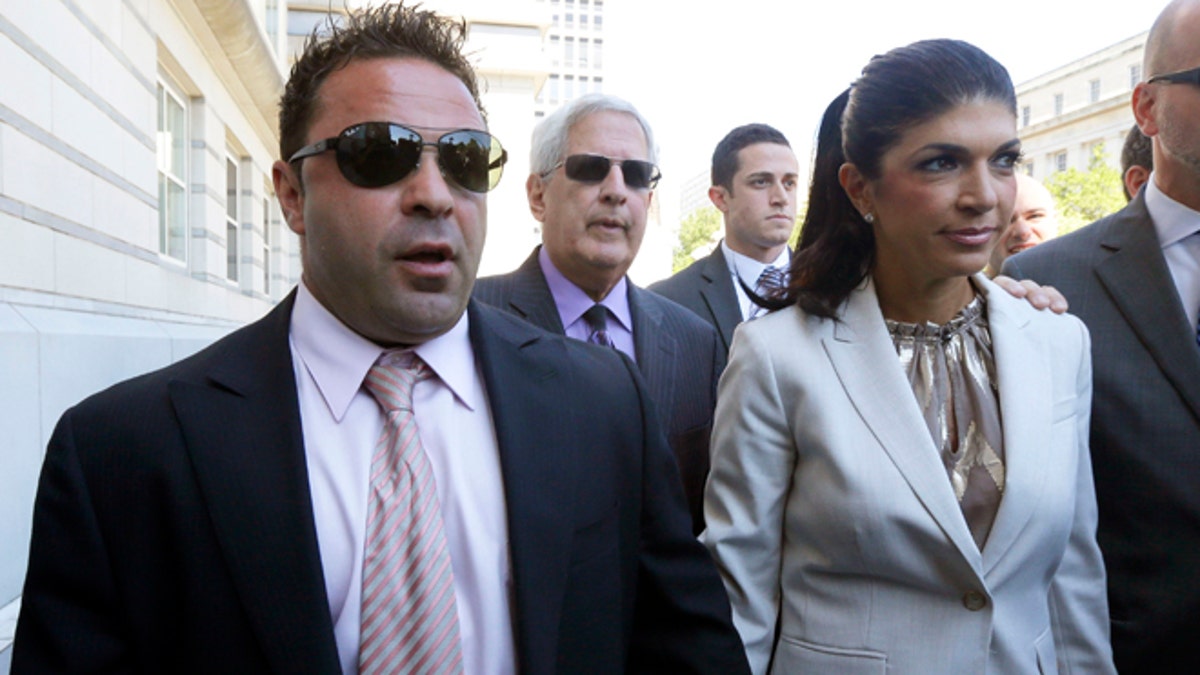 Giuseppe "Joe" Giudice, 43, left, and his wife, Teresa Giudice, 41, of Montville Township, N.J., walk out of Martin Luther King, Jr. Courthouse after a court appearance, Tuesday, July 30, 2013, in Newark, N.J. 