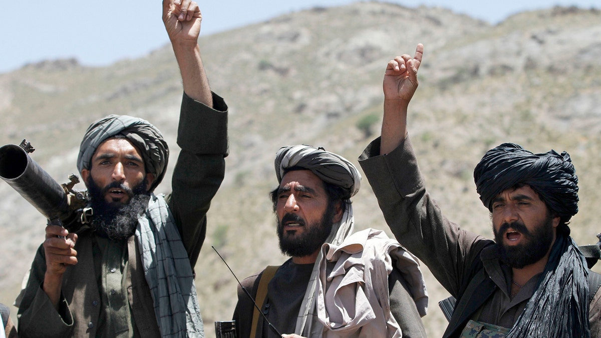 FILE - In this May 27, 2016 file photo, Taliban fighters react to a speech by their senior leader in the Shindand district of Herat province, Afghanistan. After operating out of Pakistan for more than a decade, the leaders of Afghanistans Taliban movement may have moved back to their homeland to try to build on this years gains in the war and to establish a permanent presence. If confirmed, the move would be a sign of the Talibans confidence in their fight against the U.S.-backed government in Kabul. (AP Photos/Allauddin Khan, File)