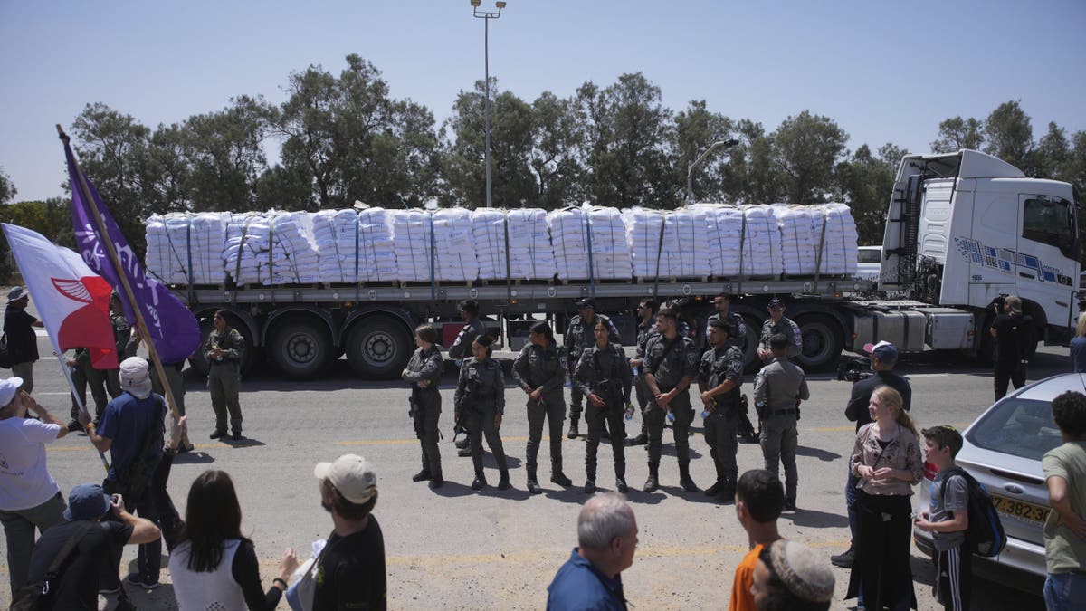 Soldiers standing in front of a humanitarian aid truck