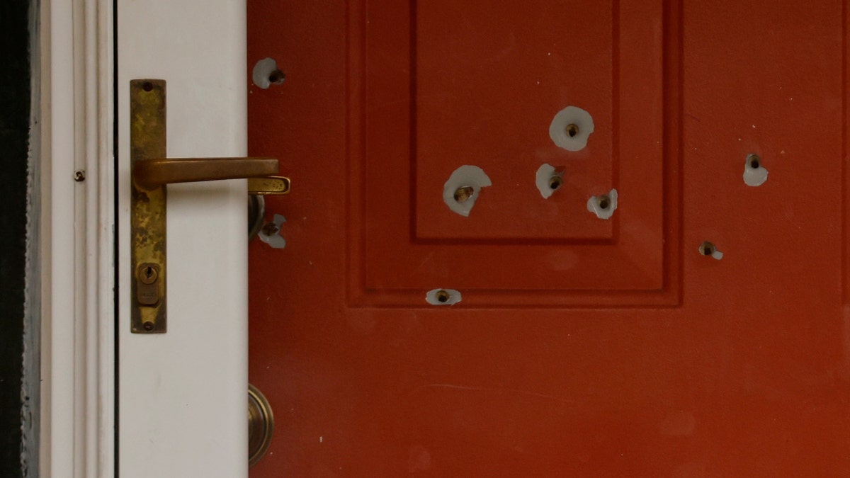 Bullet holes mark the front door of the house of Minnesota state Sen. John Hoffman and his wife who were shot earlier in the day, Saturday, June 14, 2025, in Champlin, Minn.