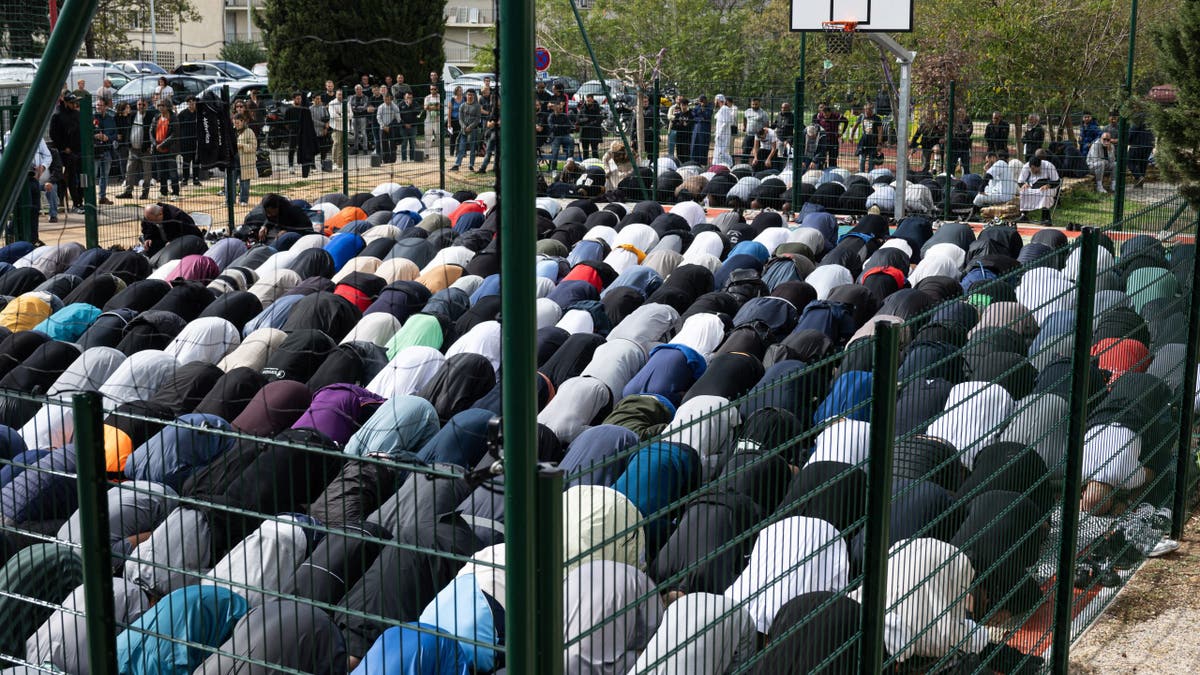 Some French Muslims criticized the report on the Muslim Brotherhood. An unrelated photo shows Muslim men praying in Marseille, France. 