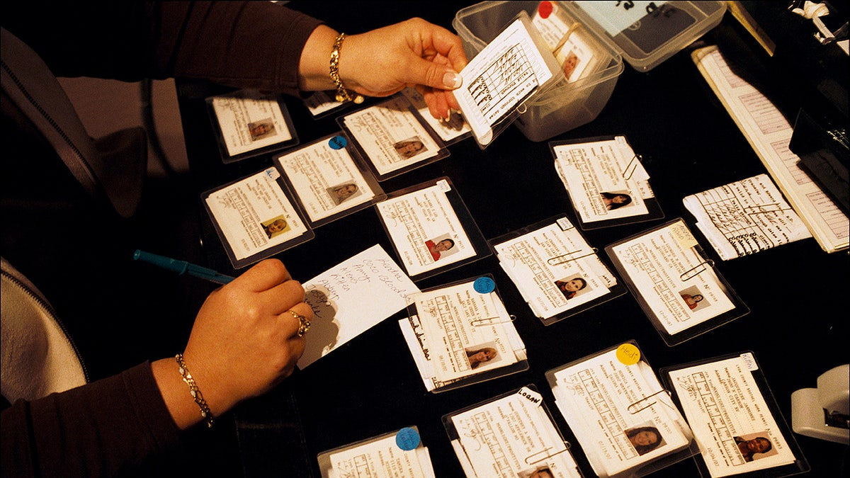 Working permits laid out on a black desk.