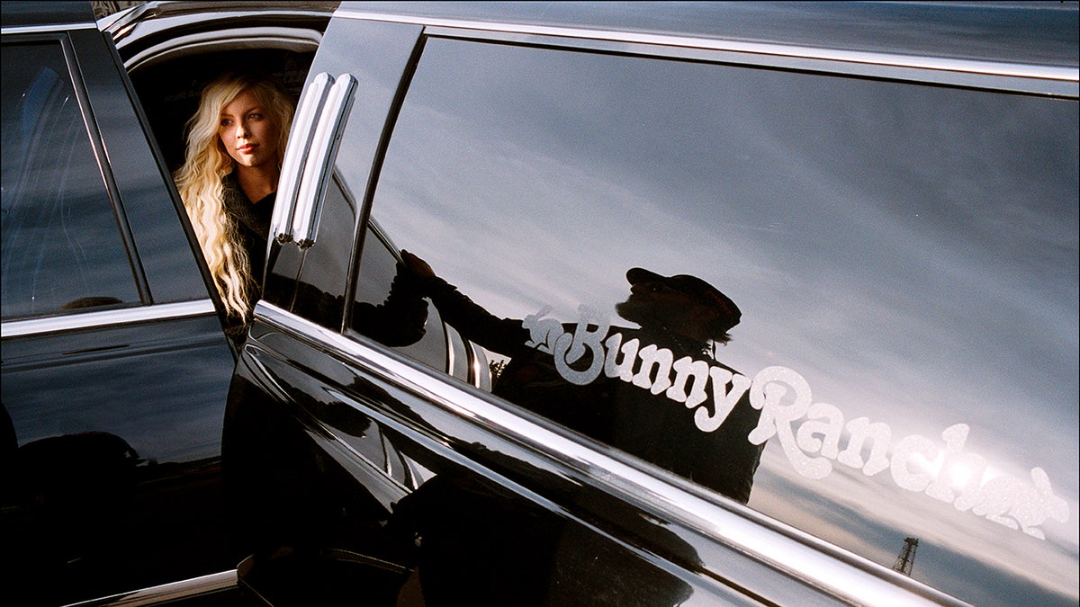 A woman stepping outside of a limo.