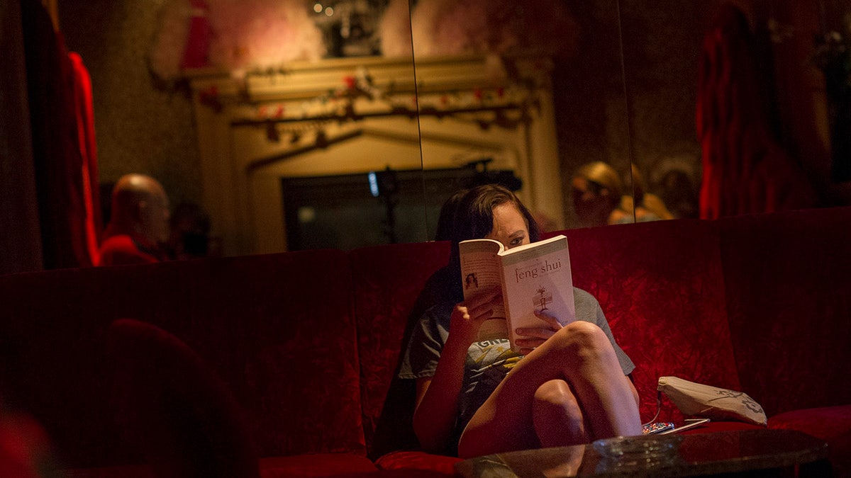 A woman reading a book at the Moonlite Bunny Ranch