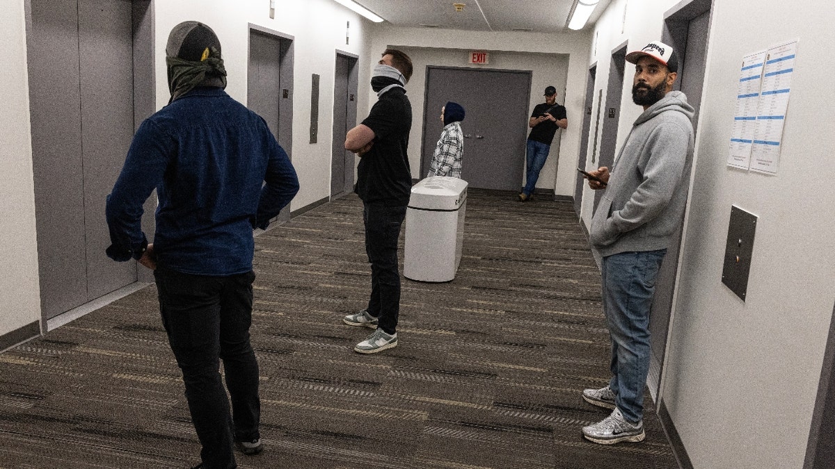 Plainclothes Immigration and Customs Enforcement (ICE) officers wait in the hallway of a Federal immigration court to arrest and deport immigrants leaving their scheduled court appearances on June 3, 2025 in New York City.