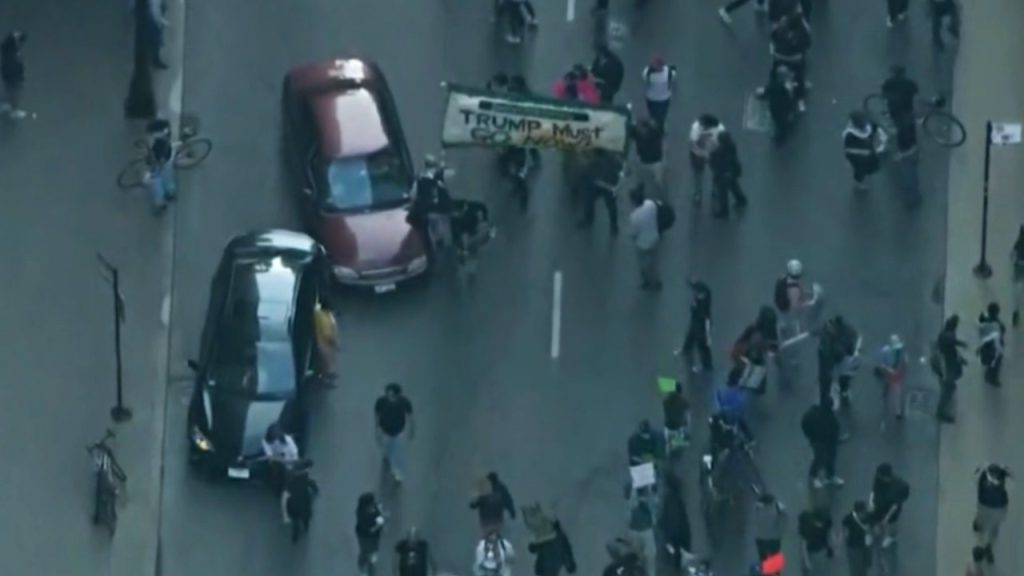 Car drives through anti-ICE protesters as Chicago joins nationwide anti-ICE unrest amid Trump crackdown